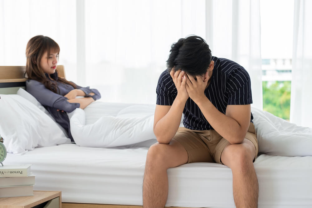 Disheartened couple experiencing low libido and emotional disconnect from hormonal imbalance